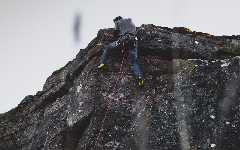 person rock climbing