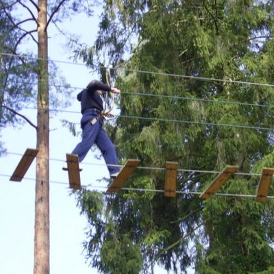 someone walking across a rope ladder
