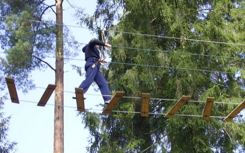 someone walking across a rope ladder
